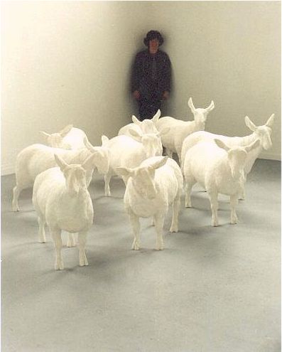 Angela Hunter with her original flock of plaster sheep, exhibited in her degree show in 1999